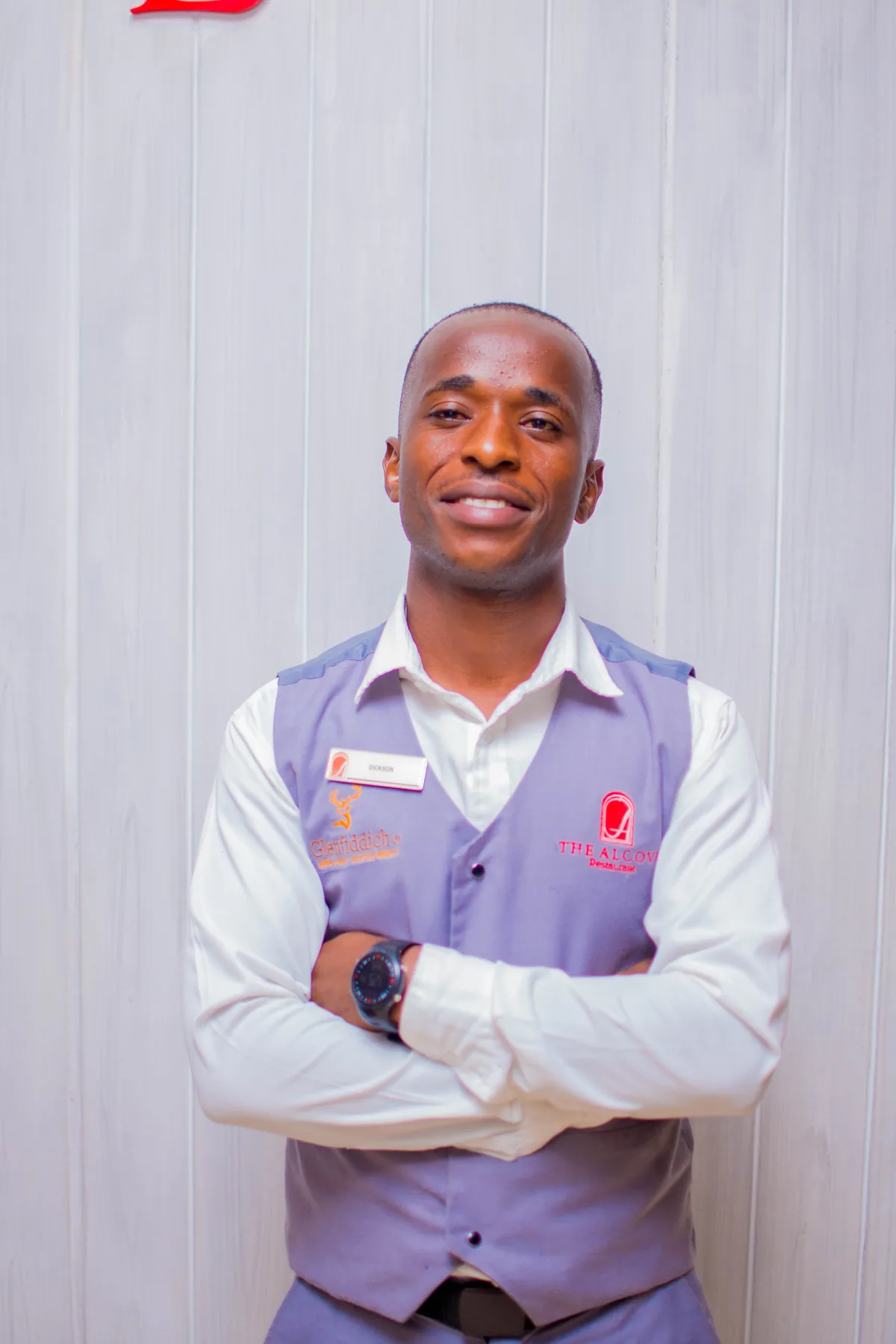 An Alcove host in uniform welcoming guests